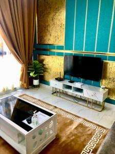哥打巴鲁AAIRA Troika Residence,Kota Bharu的客厅配有平面电视和桌子。