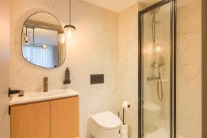 波尔图Icon Apartments by NÔMA的浴室配有卫生间、盥洗盆和淋浴。