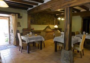 Vada拉卡萨德拉斯阿卡斯酒店的一间带桌椅和壁炉的用餐室