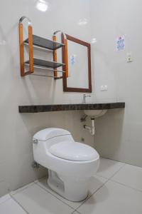 瓜亚基尔Hotel Murali - Cerca del Aeropuerto de Guayaquil的浴室设有白色的卫生间和镜子