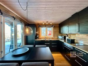 兰帕兰德Cozy cabin with incredible views and sauna的厨房配有黑色桌子和水槽