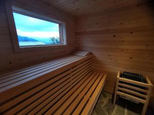 佐尔尼耶戈迪MY TIME Holiday House with sauna的一个带窗户和木凳的桑拿浴室
