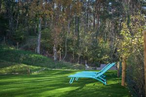 龙卡尔Arpetxea casa rural的坐在院子里草地上的蓝色长椅