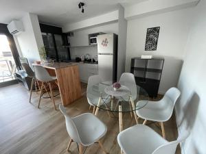 蒙得维的亚UruSamKa Apartamento 2 dormitorios en Centro MoNteVidEo的厨房配有桌椅和冰箱。