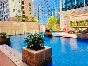 马尼拉Deluxe Queen 1BR Luxury Suite 11 - Pool, City View的一座位于高楼城市的游泳池