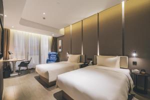 上海上海北外滩亚朵酒店的酒店客房配有两张床和一张书桌