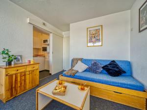 勒克比尔Apartment Lunik Orion-41 by Interhome的客厅配有蓝色的沙发和桌子