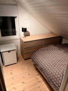 特罗姆瑟Tromsø’s best location? City & Nature 5 mins away.的一间卧室配有一张床、一个梳妆台和一扇窗户。