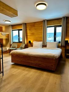 里茨勒恩Alpen Lodge Riezlern的一间带一张大床的卧室,位于带窗户的房间内