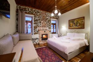奥吉欧司吉玛洛斯Agios Germanos的一间卧室设有一张床,客厅设有壁炉。