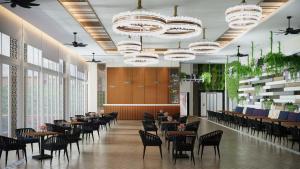 雅加达Oakwood Suites Kuningan Jakarta的餐厅设有桌椅和吊灯。