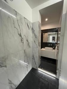 罗马马鲁帕之家豪华公寓的带淋浴、水槽和镜子的浴室