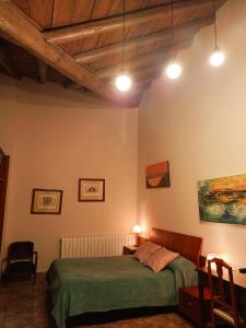 CadreitaCasa rural de la Abuela的一间卧室配有一张床、一张桌子和灯