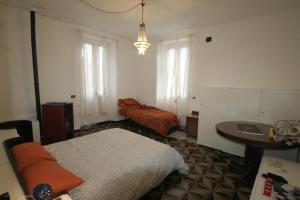 GorretoB&B Jolly Gorreto的卧室配有床、桌子和窗户。