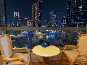 迪拜Living Room JBR的阳台配有桌椅,享有城市天际线
