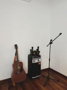 莎阿南The Classy RomaAkar的一间设有吉他、扬声器和麦克风的房间