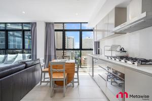 悉尼MetaWise Sydney CBD Haymarket Luxe 2Bed Penthouse Bella的带沙发和桌子的厨房