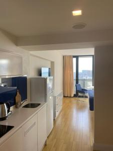 巴统Orbi Сity Sunny Apartments high floor的配有白色家电的厨房和客厅