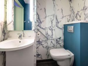 圣艾蒂安Ibis budget Saint-Étienne stade的一间带水槽、卫生间和镜子的浴室