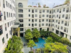 北宁LaLaHome Bắc Ninh的公寓大楼设有种有棕榈树的庭院