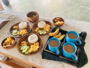 伊洛伊洛Balai Lawaan Charming Sanctuary的餐桌,盘子上放着食物和咖啡