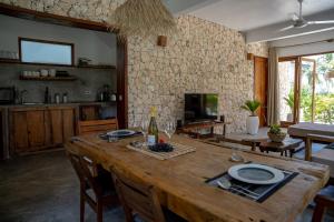 平圭Natural Park Villa Resort的一间带木桌的客厅和一间厨房