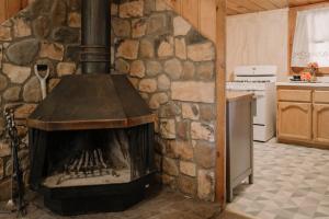 大熊湖2406 - Oak Knoll #8 cabin的带炉灶的厨房内的石头壁炉