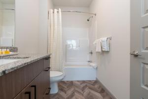 乌尔班纳Yugo Guest Suites的白色的浴室设有卫生间和淋浴。