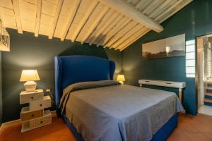 PietravivaRelais La Martina的一间卧室配有一张床和一张蓝色椅子