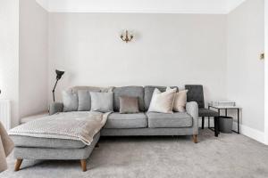伦敦Luxury 3 bedroom apartment in the heart of High Street Kensington, London.的客厅配有灰色的沙发和椅子