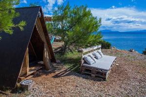 萨瓦拉Cast Away - Eco Resort的坐在水边的山顶上的长凳