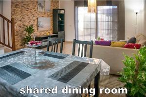 厄尔梅达诺Casa la Sonrisa的一间带餐桌的客厅和一间带沙发的客厅