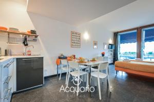 热那亚Acquario Suites的厨房以及带桌椅的起居室。