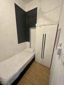 宾南邦SW Rental的小房间设有一张床和一台冰箱
