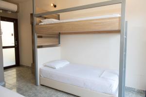 TrikovilónTota Marinou的卧室配有带白色床单的双层床