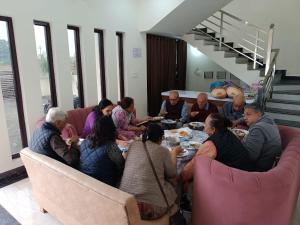 奥拉奇哈Hotel saanjh haveli的一群坐在桌子旁吃饭的人