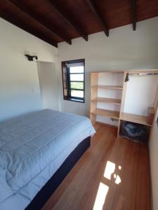 拉帕洛马Casas frente a la Playa的一间卧室设有一张大床和一个窗户。