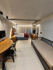 塔曼达雷Praia dos Carneiros flat hotel的一间卧室配有一张床、一张桌子和一张桌子