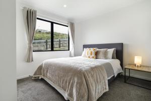 汉密尔顿Stunning 3 bedrooms house in Hillcrest - Close to Waikato University & Cambridge的白色的卧室设有床和窗户