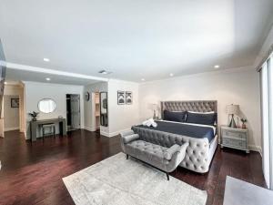洛杉矶Charming 6BR Family Home with Private Pool -ENC-UC的一间大卧室,配有一张床和一张沙发