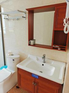 梅州湄洲岛悦榕湾民宿的一间带水槽、卫生间和镜子的浴室