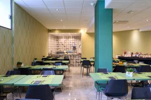 巴塞罗那加泰罗尼亚酒店普特埃特公园店的用餐室配有绿色的桌椅
