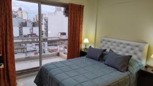 布宜诺斯艾利斯Flores Finesse的一间卧室设有一张床和一个大窗户