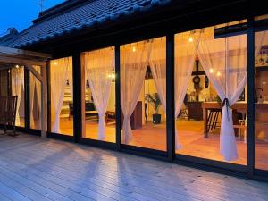 长野vintagehouse1925Bali - Vacation STAY 14502的客房设有带白色窗帘的大窗户。