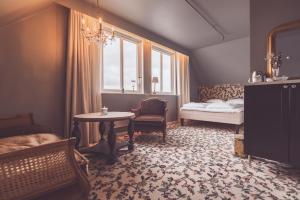 特罗姆瑟Villa Havblikk Tromsø的一间卧室配有一张床、一张桌子和一个窗户。