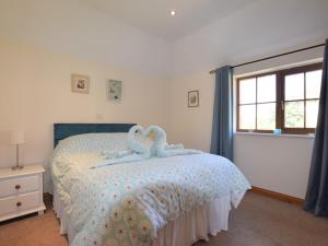East Harling2 Bed in Thetford 64075的卧室配有一张床上的2个天鹅