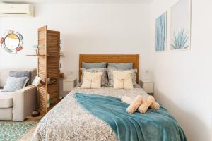 托雷德尔马尔La Palometa的一间卧室配有一张带蓝色毯子的床