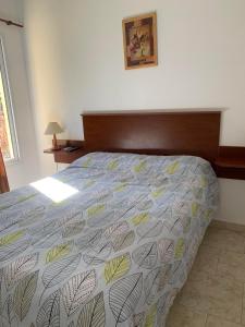 科隆Complejo Rincon del Uruguai的一间卧室配有一张床,床罩上放着树叶