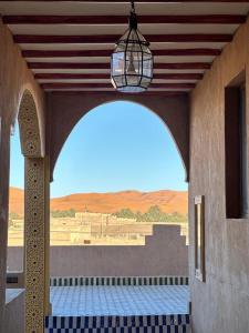 梅尔祖卡骆驼之家住宿加早餐旅馆的拱门,从建筑物中可欣赏到沙漠景色