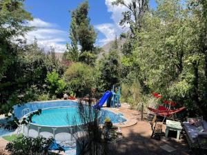 圣阿方索Acogedora cabaña entre montañas的树木繁茂的庭院中的一个游泳池